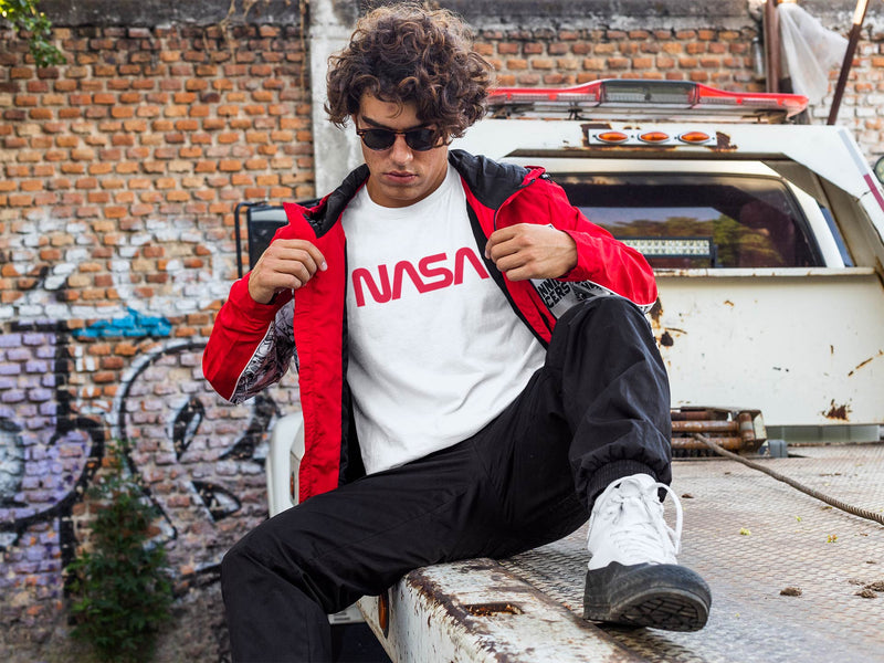 Guy wearing Nasa worm logo in red text on white short sleeve.