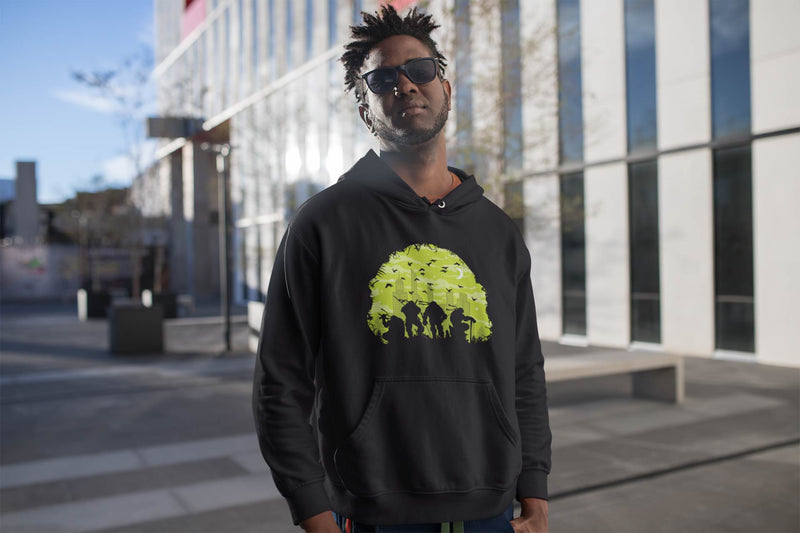 Guy wearing Black hoodie with ninja turtles outlined in a tree city scape.