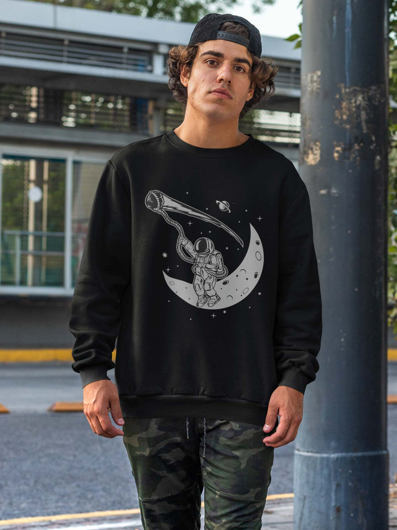 Black crewneck sweatshirt on a male model with an astronaut lassoing a meteor while sitting on the crescent moon. 