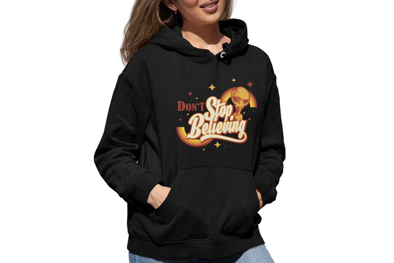 woman wearing black hoodie with a retro print of an alien and the text "don't stop believing".