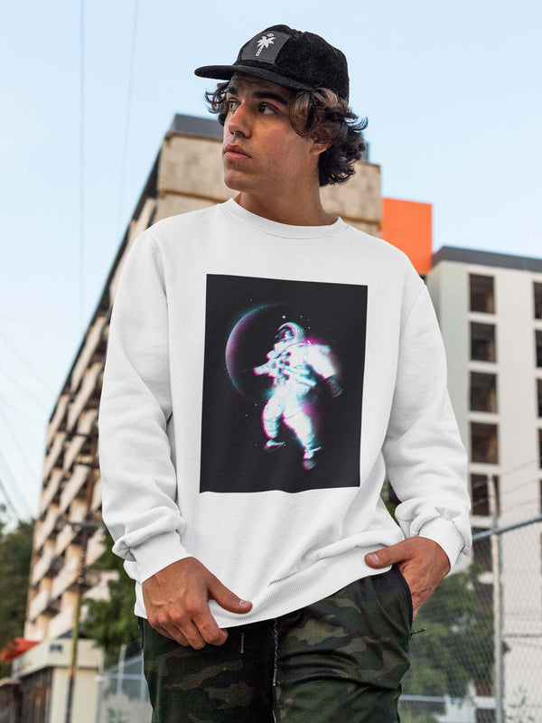 Man in white crewneck sweatshirt with a blurred astronaut floating in space infant of blurry planet in background. Full color print. 
