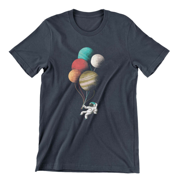 Midnight Blue t-shirt with a graphic print of an astronaut floating in space being supported by planet like balloons.